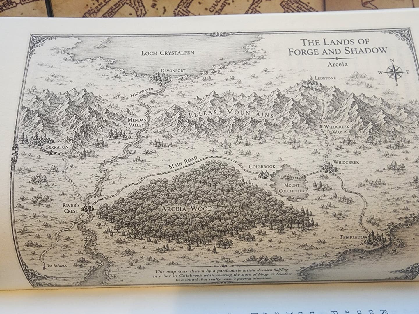 Printed regional map titled The Lands of Forge and Shadow inside the physical paperback proof